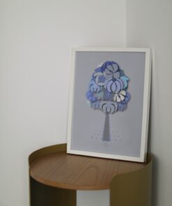 blue geometrical tree small poster in a white frame on a wooden table