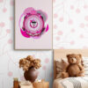 Magenta Supersister Cat poster hangs in a vintage girl's room. The playful cartoon cat, with a pink and purple color scheme and a decorative bobbin on her head, contrasts with the delicate floral wallpaper. A brown teddy bear sits on a brown side table next to the poster