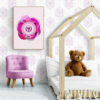 Magenta Superbaby Cat, a wide-eyed kitten with a big, cute soother. The poster hangs in a cozy toddler's bedroom with low-bed, filled with fluffy teddy bears, creating a super sweet and calming atmosphere
