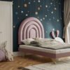 Pink half rainbow upholstered headboard in kids room