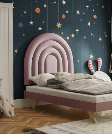 Pink half rainbow upholstered headboard in kids room
