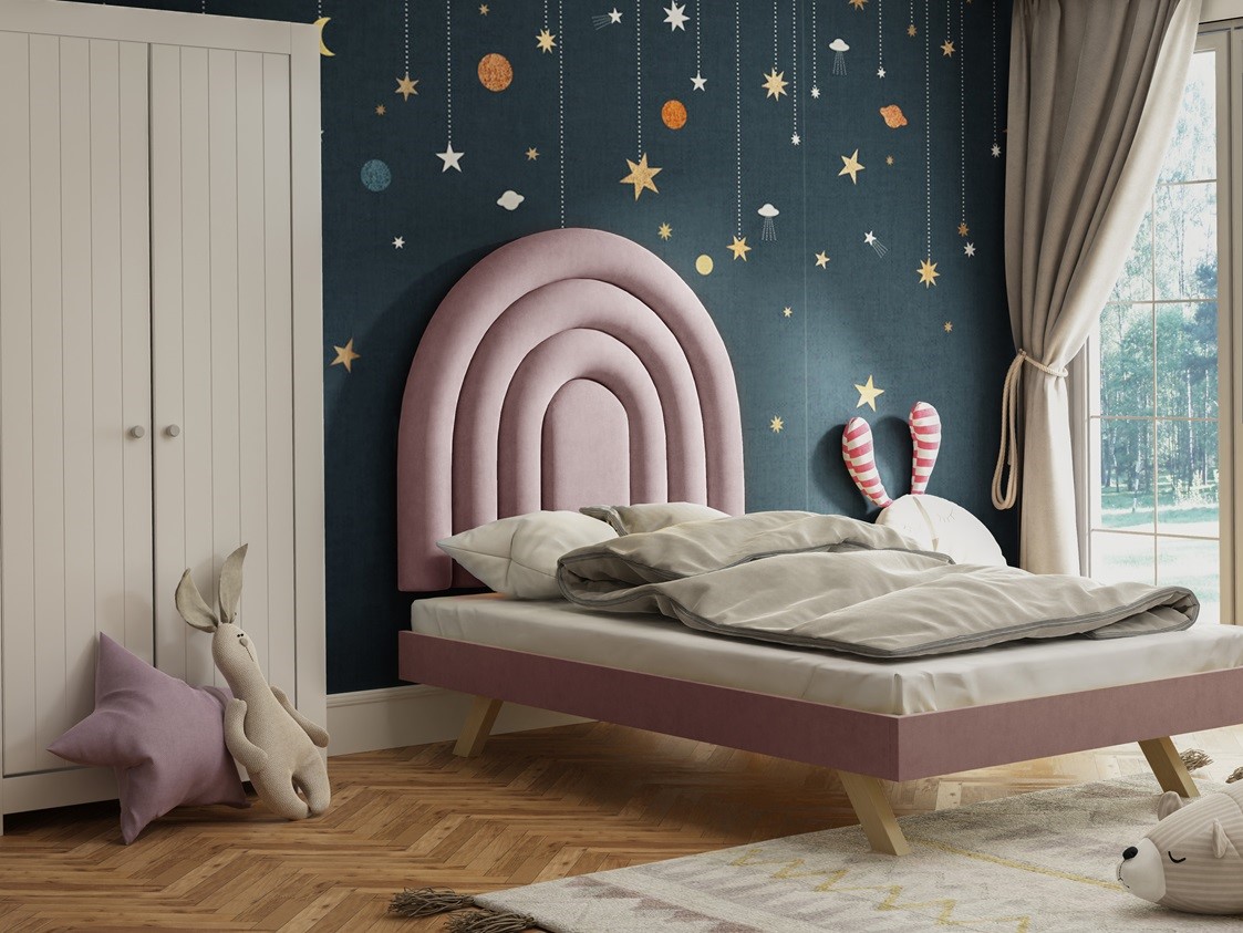 Pink half rainbow upholstered headboard in kids room