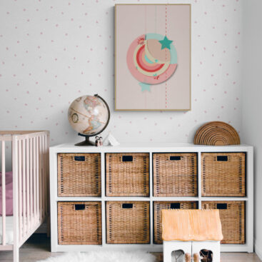 Red and green moon framed poster in a vintage look nursery with rattan decor