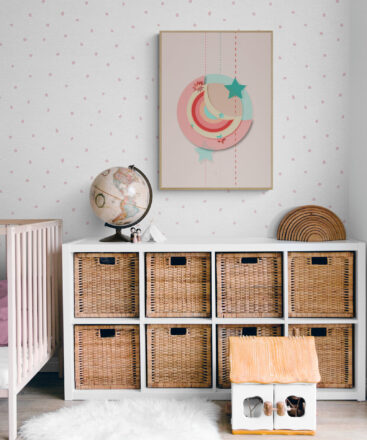 Red and green moon framed poster in a vintage look nursery with rattan decor