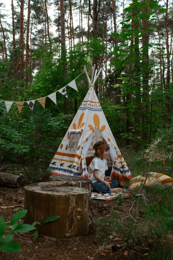 Teepee Indian Vibe in a forest with little boy