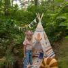 Teepee Indian Vibe in a wild with little girl having an adventure in forest