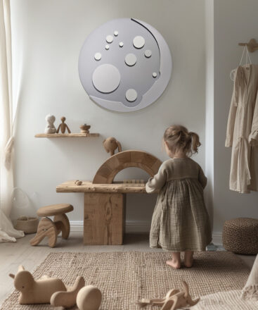 Grey Moon wall decor in a neutral and organic kids interior with little girl