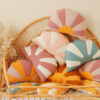 comfortable and solid sun pillow collections in blue white orange and pink white and red and orange on a wicker chair