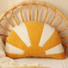 comfortable and solid sun pillow in white orange and on a wicker chair