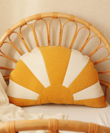 comfortable and solid sun pillow in white orange and on a wicker chair