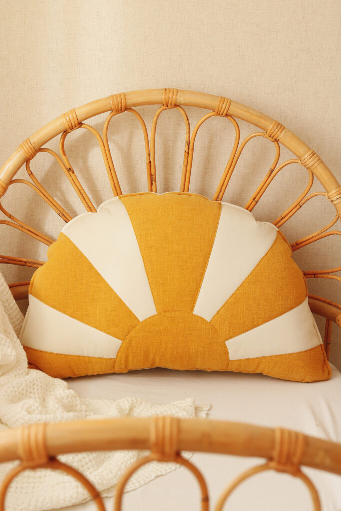 comfortable and solid sun pillow in white orange and on a wicker chair