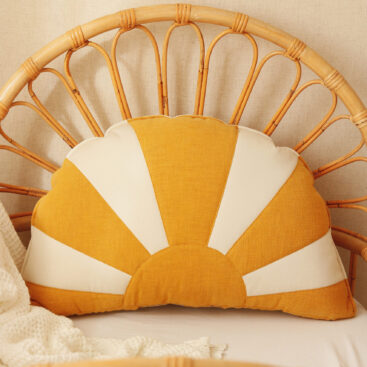 comfortable and solid sun pillow in white orange and on a wicker chair