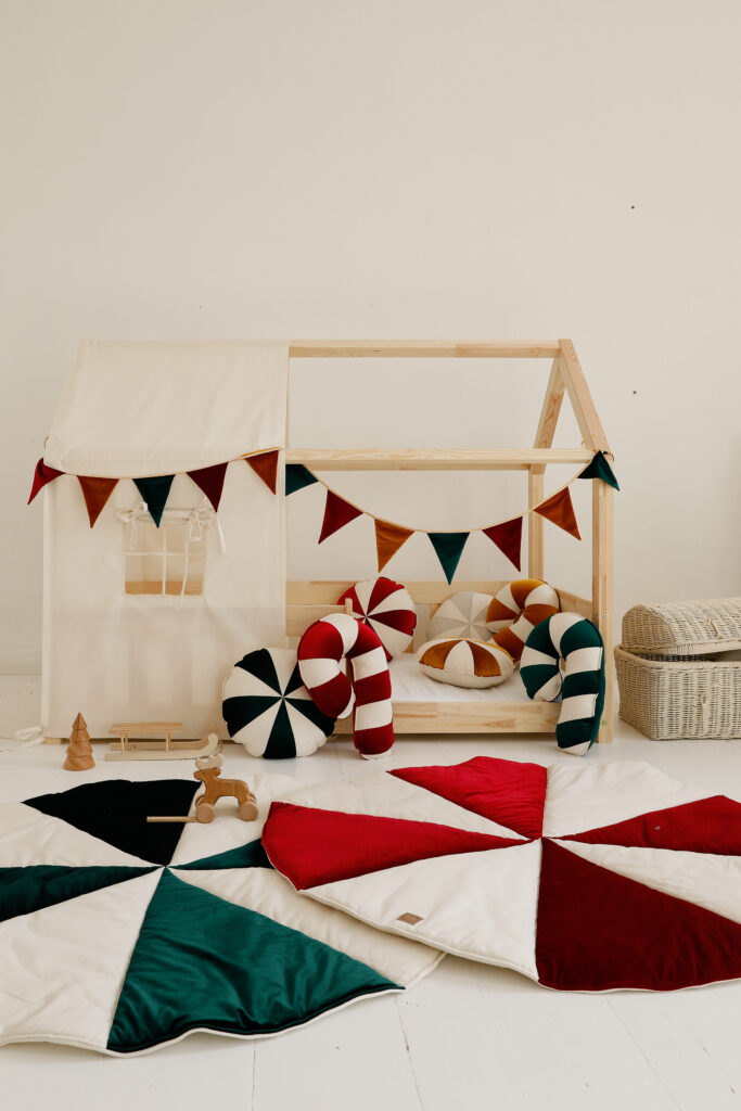 raw cotton bed canopy over house bed with colourful circus mats and pillows