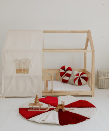 raw cotton bed canopy over house bed with colourful circus mats and pillows