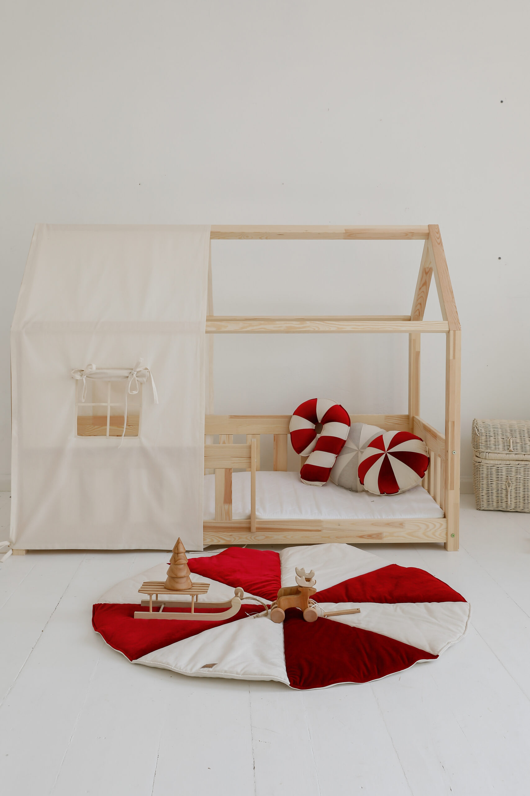 raw cotton bed canopy over house bed with colourful circus mats and pillows