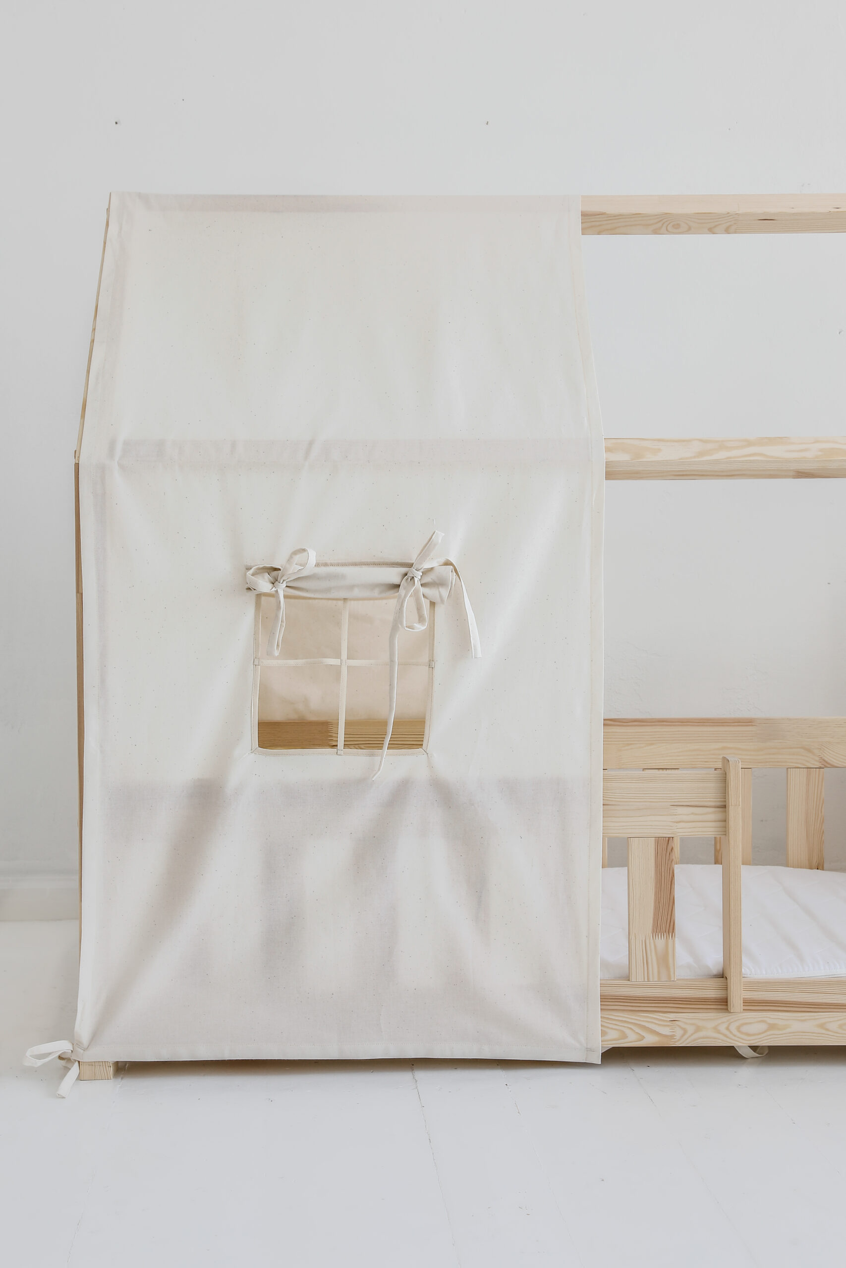 raw cotton bed canopy over house bed, neutral and raw