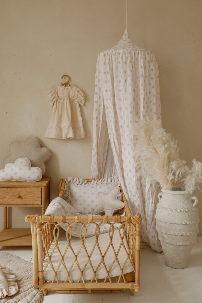 beige cotton bed canopy in gender neutral nursery room